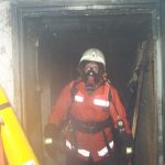 Zwei Atemschutzgeräteträger verlassen den Keller nach dem das Feuer aus war
